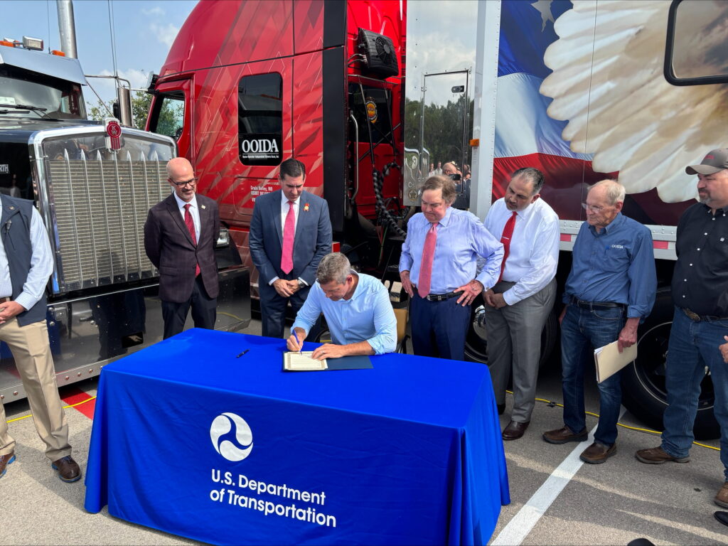 Motor carrier compliance manager reviewing USDOT records after an English proficiency violation